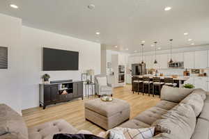 Living area featuring recessed lighting and light wood finished floors