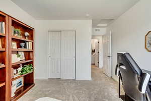 Home office featuring visible vents, carpet flooring, and baseboards