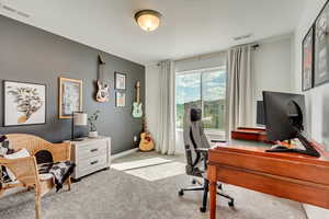 Office featuring visible vents and light colored carpet
