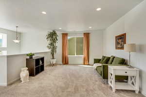 Carpeted living room featuring baseboards and recessed lighting