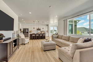 Living room featuring recessed lighting and light wood-style flooring