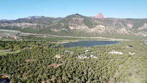 View of mountain feature with a water view and a wooded view