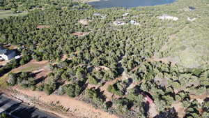 Birds eye view of property featuring a view of trees and a water view