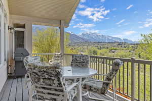 Balcony with a mountain view, a grill, and outdoor dining space