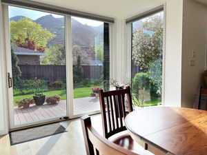 Entryway with a mountain view, expansive windows, wood finished floors, and a healthy amount of sunlight