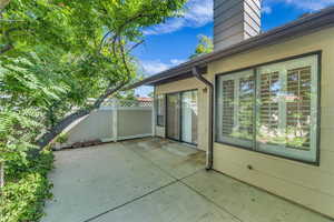 View of patio with fence