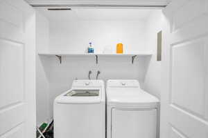 Laundry room featuring washing machine and clothes dryer and laundry area
