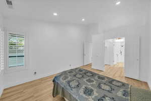 Bedroom featuring visible vents, baseboards, and light wood-style floors