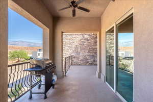 Balcony with a mountain view, a grill, and ceiling fan