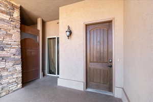 Entrance to property featuring stucco siding