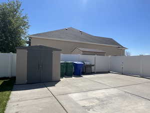 Exterior space featuring a fenced backyard, an outbuilding, and a shed