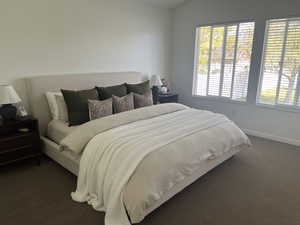 Master bedroom with lofted ceiling and views of mountains