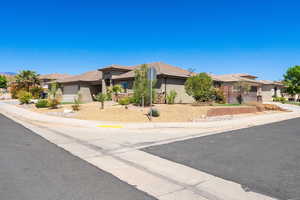 View of front of house with a garage, a residential view, a tiled roof, and stucco siding