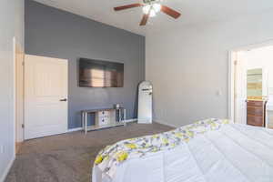 Bedroom featuring carpet floors, a ceiling fan, baseboards, and ensuite bathroom