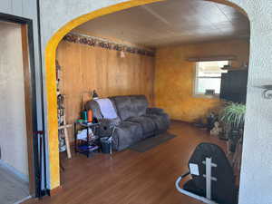 Living room featuring arched walkways and wood finished floors