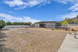 View of yard with an exterior structure, a detached carport, and an outdoor structure