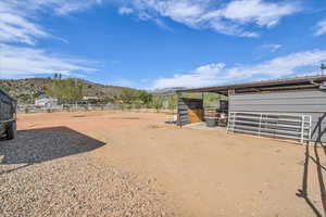 View of yard with an exterior structure, an outbuilding, and a mountain view