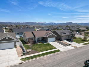 View of front of property featuring board and batten siding, a residential view, and concrete driveway