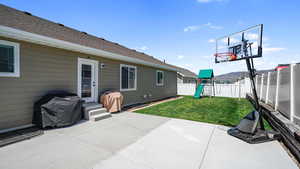 View of patio / terrace featuring a fenced backyard, a playground, and a grill