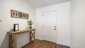 Entrance foyer featuring dark wood finished floors and baseboards