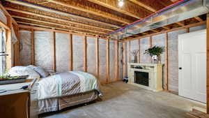Bedroom with unfinished concrete floors