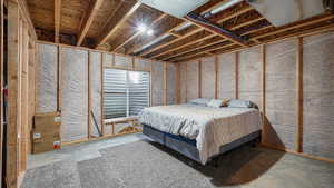 Bedroom featuring unfinished concrete flooring