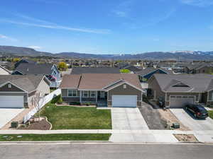 Single story home featuring driveway, a mountain view, and a residential view