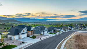 Aerial view at dusk featuring a mountain view and a residential view