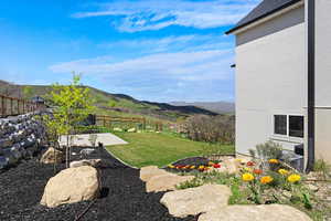 View of yard with a patio, a fenced backyard, and a mountain view