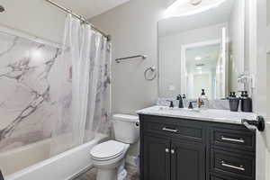 Full bathroom with shower / bath combination with curtain, wood finished floors, visible vents, toilet, and vanity