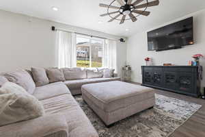 Living room with baseboards, wood finished floors, recessed lighting, and ceiling fan
