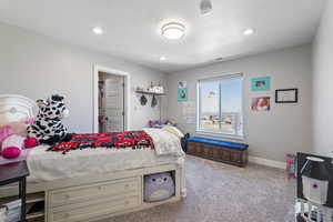 Carpeted bedroom with recessed lighting, a textured ceiling, baseboards, and visible vents