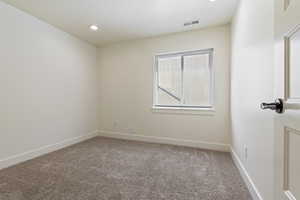 Unfurnished room featuring baseboards, visible vents, recessed lighting, and carpet flooring