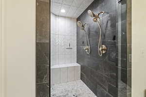 Bathroom featuring a tile shower and recessed lighting