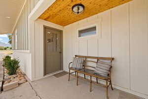 Property entrance featuring board and batten siding