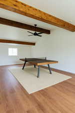 Game room featuring a ceiling fan, baseboards, beam ceiling, and light wood-style floors