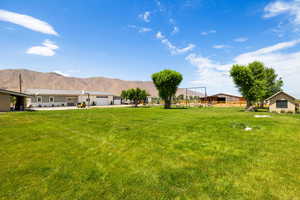 View of yard with a garage and a mountain view