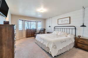 Bedroom featuring baseboards and light carpet