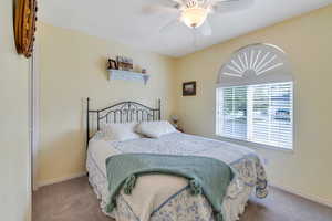 Bedroom featuring carpet, a ceiling fan, and baseboards