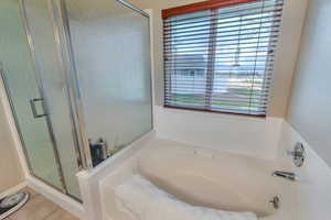 Full bathroom with a bath, a shower stall, and tile patterned floors