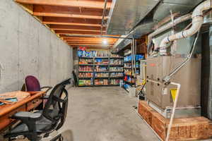 Unfinished basement featuring heating unit