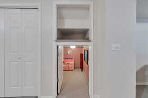 Hall featuring carpet floors and baseboards