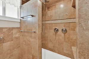 Full bathroom featuring a tile shower