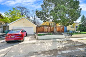 Exterior space with an outdoor structure, fence, and a garage