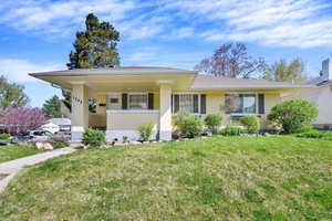View of front of house with a front lawn and brick siding