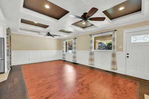 Foyer entrance featuring crown molding, a ceiling fan, and coffered ceiling