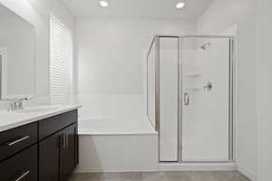 Bathroom with a garden tub, vanity, recessed lighting, and a stall shower