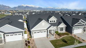 View of front of property with stone siding, a residential view, board and batten siding, and a mountain view