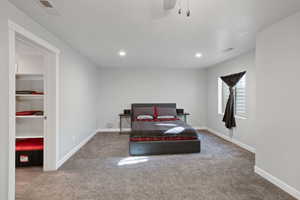 Bedroom with baseboards, carpet flooring, and visible vents