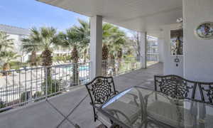 View of patio with a balcony